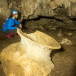 Shayna toiling behind this beautiful Mayan vessel in a Belizean cave.