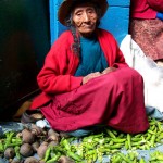 Shucking bean pods in the streets of Cuzco, Peru.